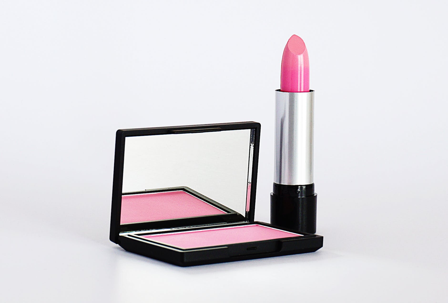 bright poppy pink blush and lipstick in black packaging